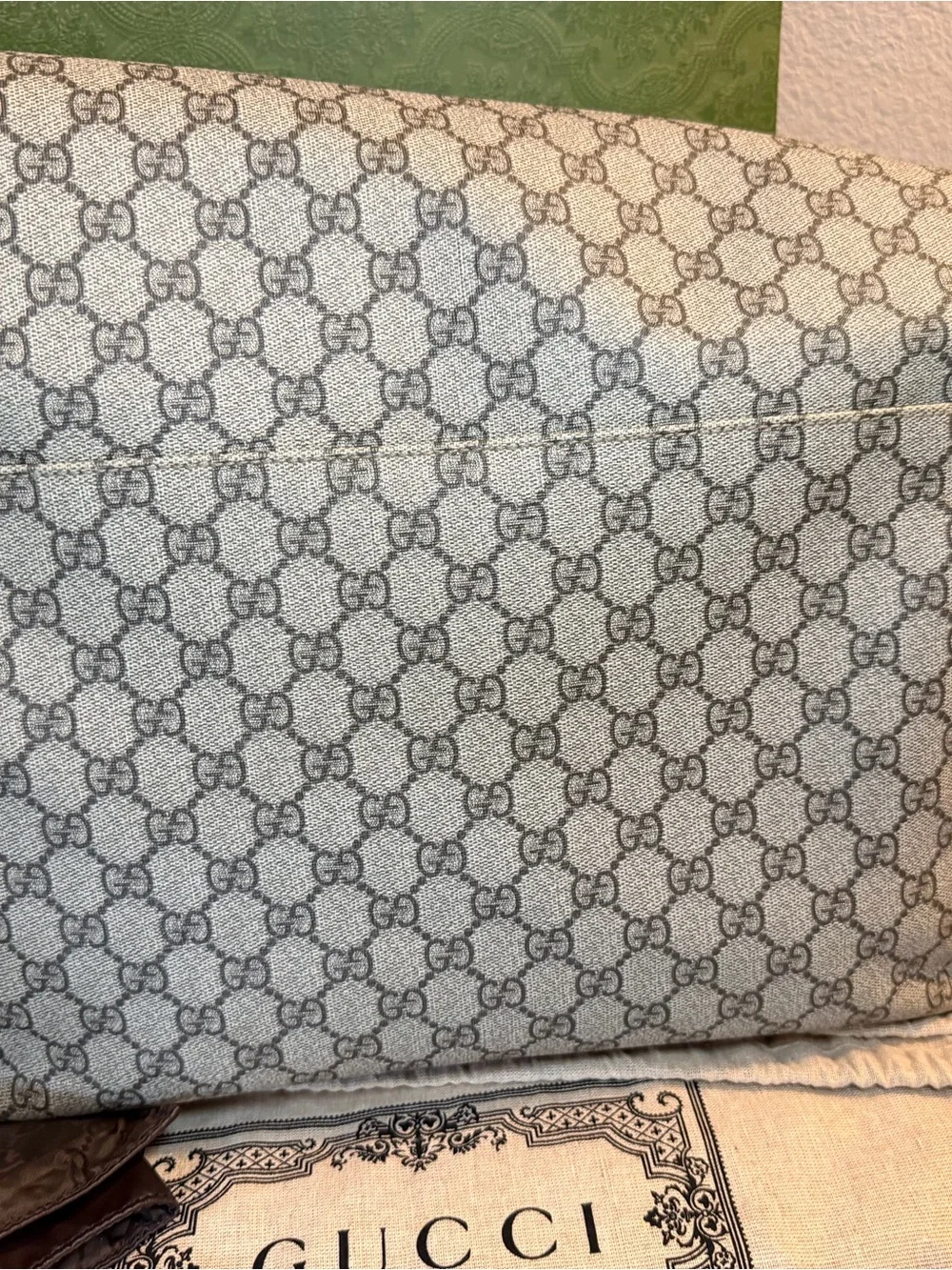 GG Supreme canvas diaper bag, designed with multiple pockets and fold-out pad